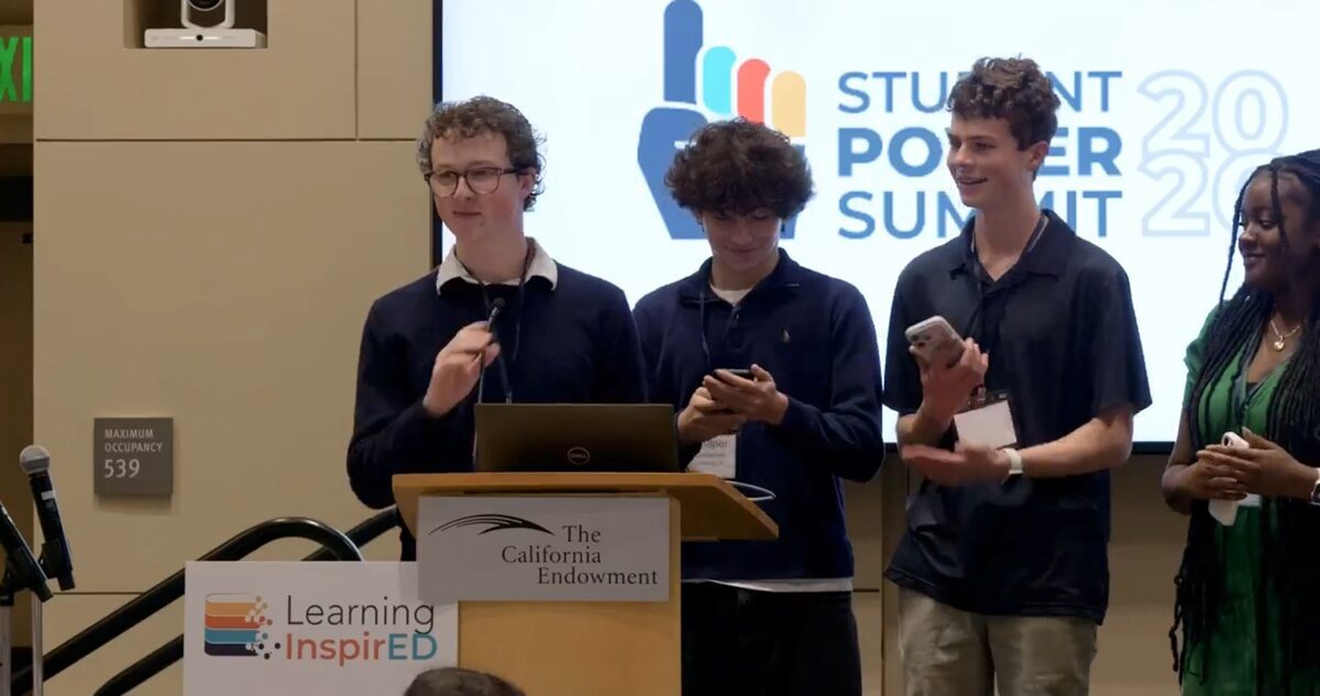 Student leaders presenting on stage at the Student Power Summit.