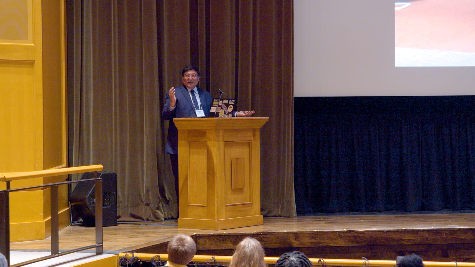 Dr. Sugata Mitra presenting from the stage at the McCoy Theater.