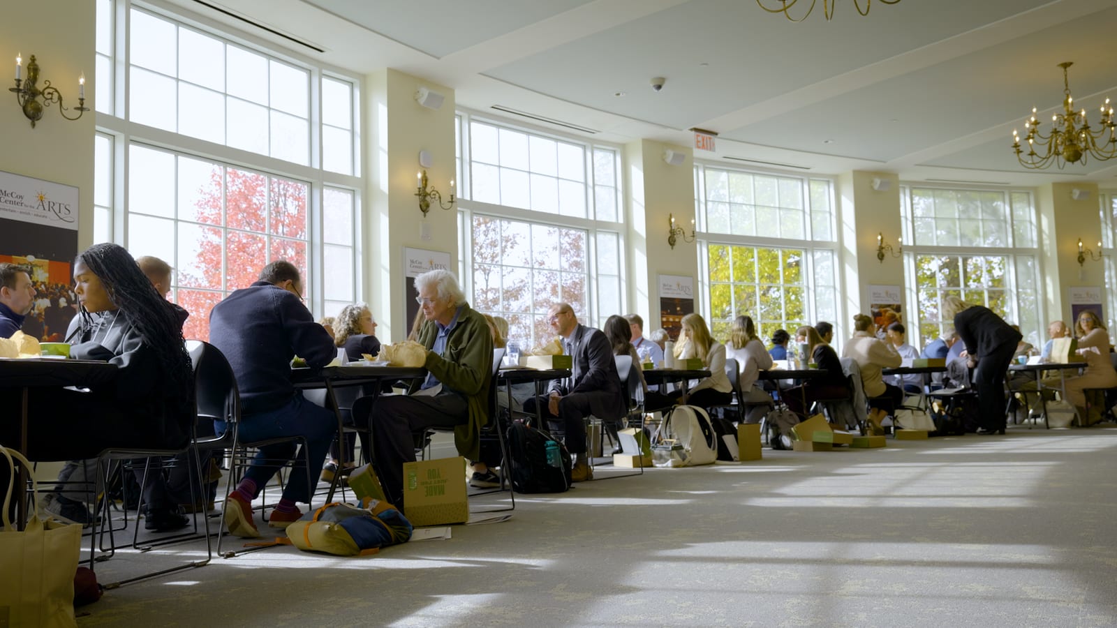 Attendees networking over lunch in the sunlit McCoy Center hall.